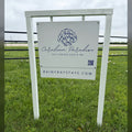Cerulean Paradise beach rental road sign we built: white frame, shell logo panel with QR code and RainyDayStays.com website rider