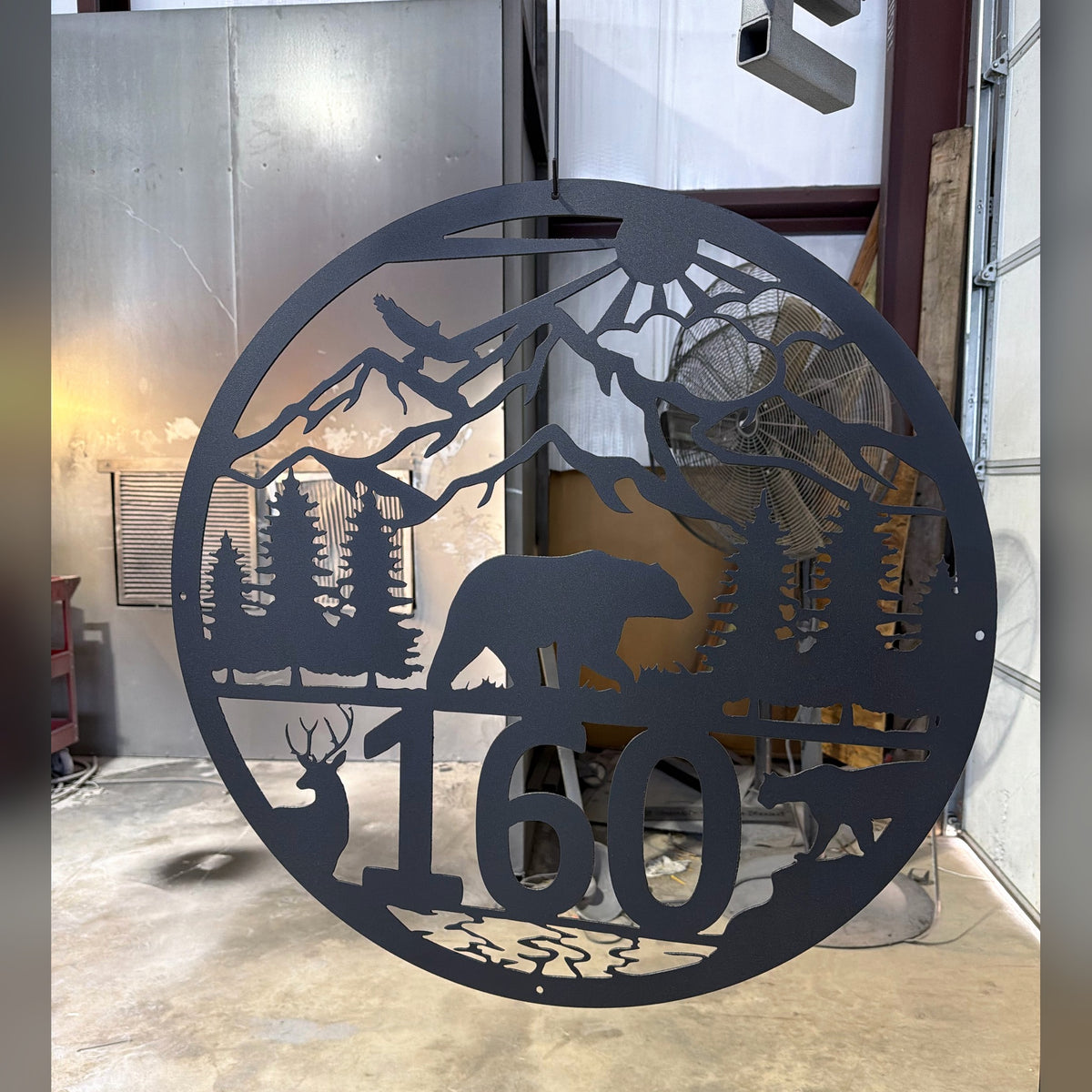 Round black mountain bear and deer address sign with house number 160, finished in our shop