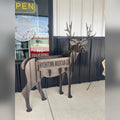 Steel deer planter sculpture with HOCHATOWN MOUNTAIN CO cut into the planter box, outside a storefront in Hochatown, Oklahoma
