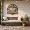 Fire Pit & Adirondack Chairs Family Name Sign in bronze, shown in a back patio