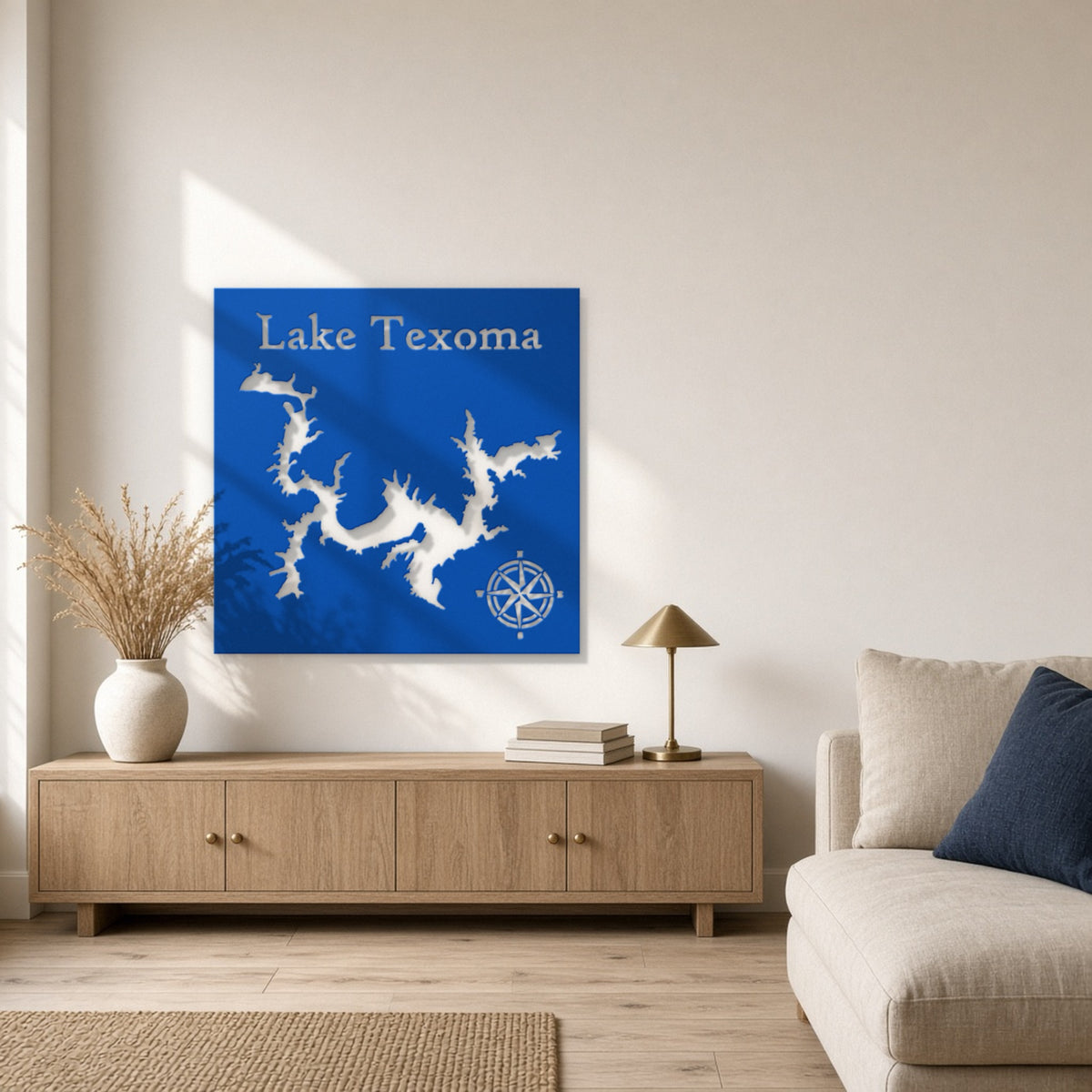 36 inch blue powder-coated steel Lake Texoma map sign with compass rose hanging above an oak console in a sunlit lake house living room