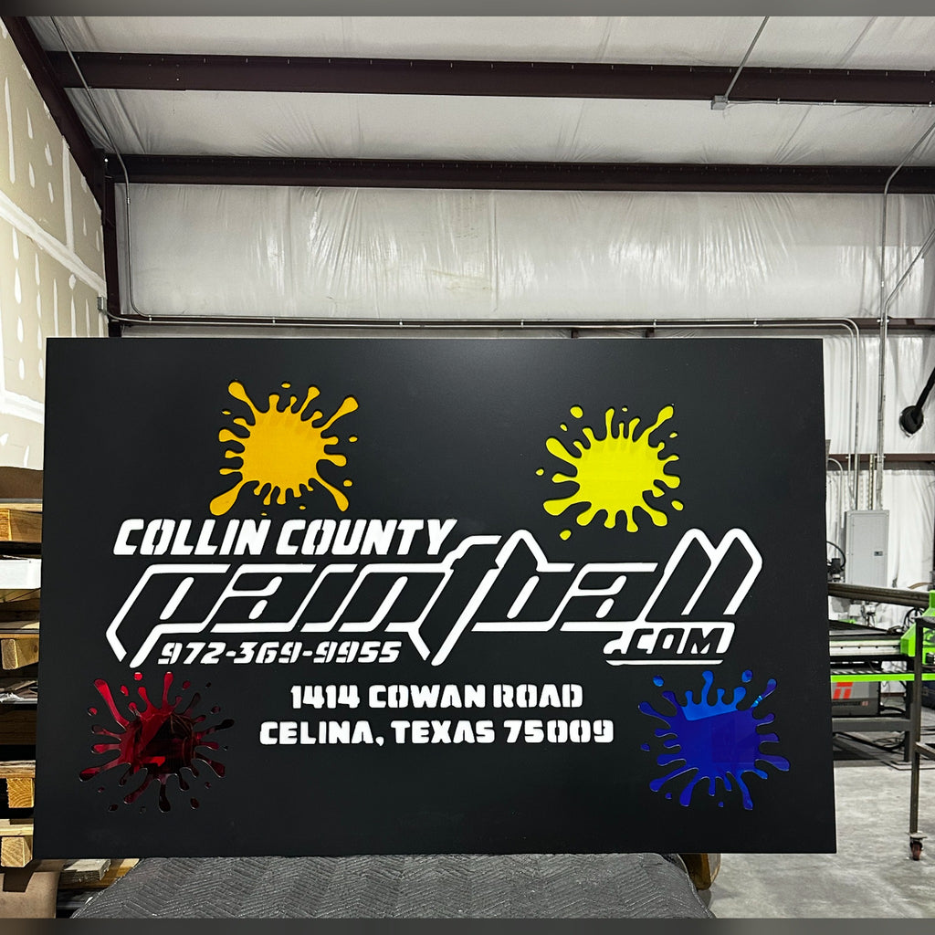Collin County Paintball LED backlit sign face with colored paint splatter inlays in the shop