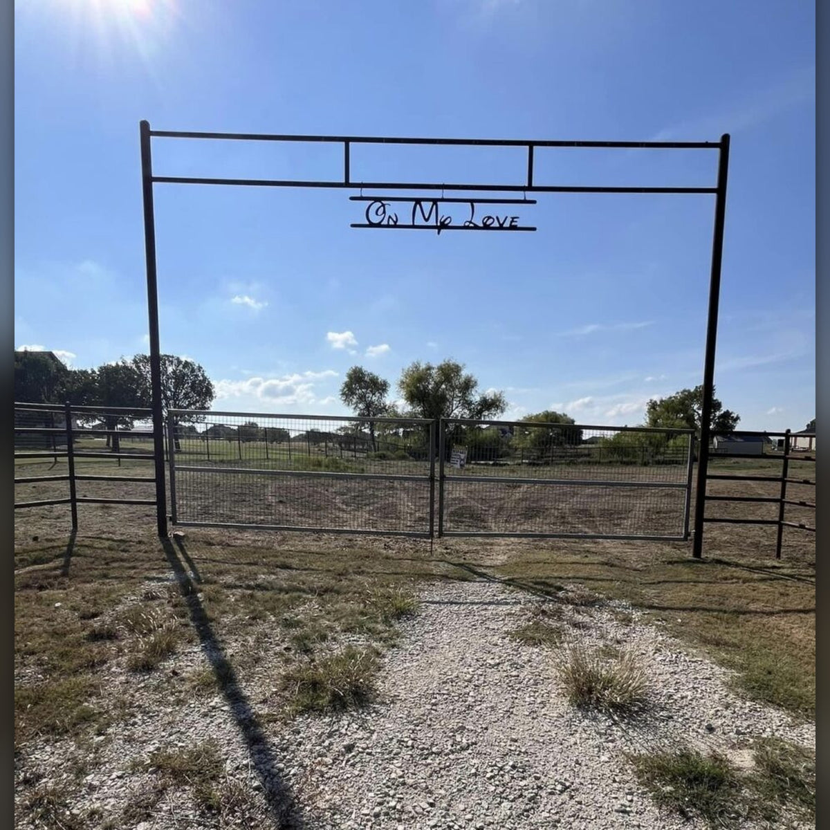 Steel ranch entrance arch with hanging name sign