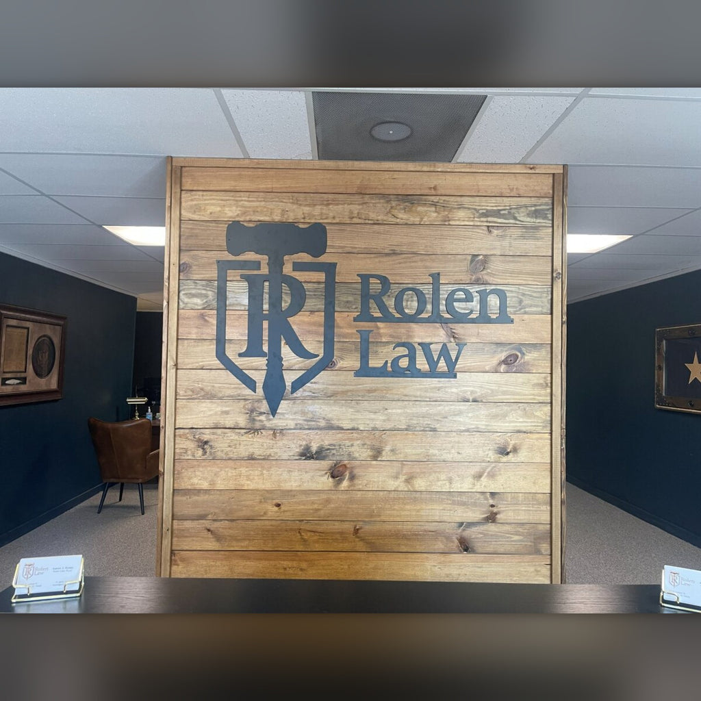 Rolen Law steel logo on wood lobby wall