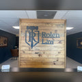 Rolen Law steel logo on wood lobby wall