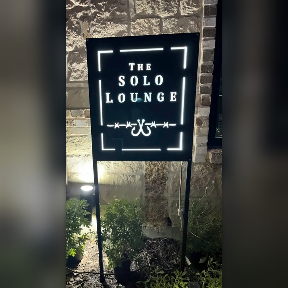 The Solo Lounge LED backlit sign at night