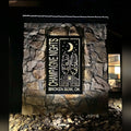 Champagne Nights Broken Bow OK backlit sign on stone wall