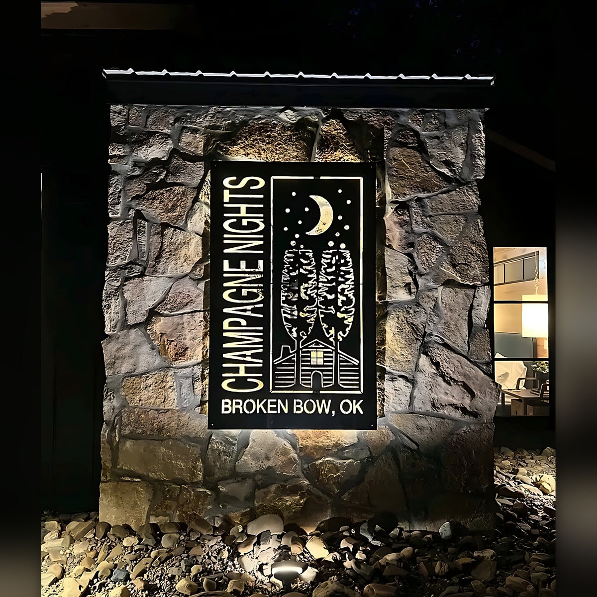 Champagne Nights Broken Bow OK backlit sign on stone wall