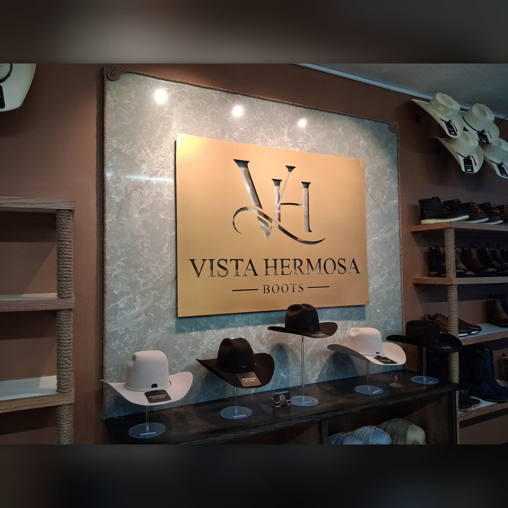Vista Hermosa Boots custom steel logo sign panel, side angle in the store
